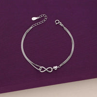 Silver infinity bracelet with a heart charm