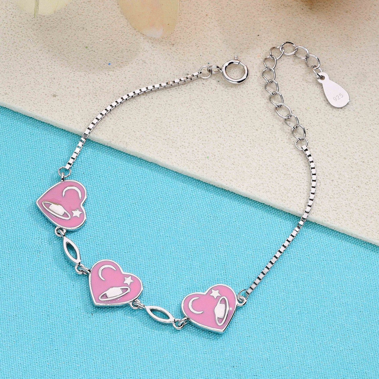 Sterling silver pink heart charm bracelet with planet, moon, and star design