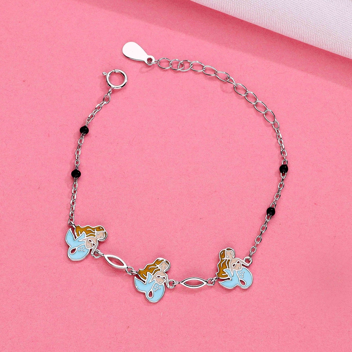 Silver mermaid charm bracelet with three pastel mermaid