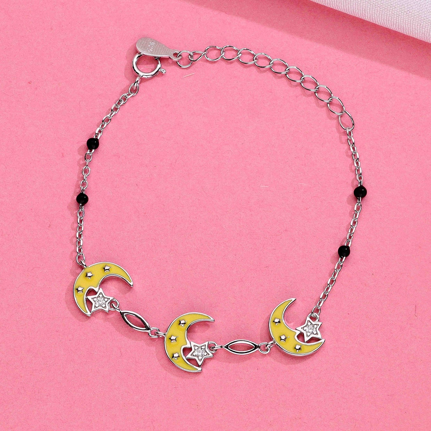 Silver chain bracelet with yellow enamel crescent moons, star charm