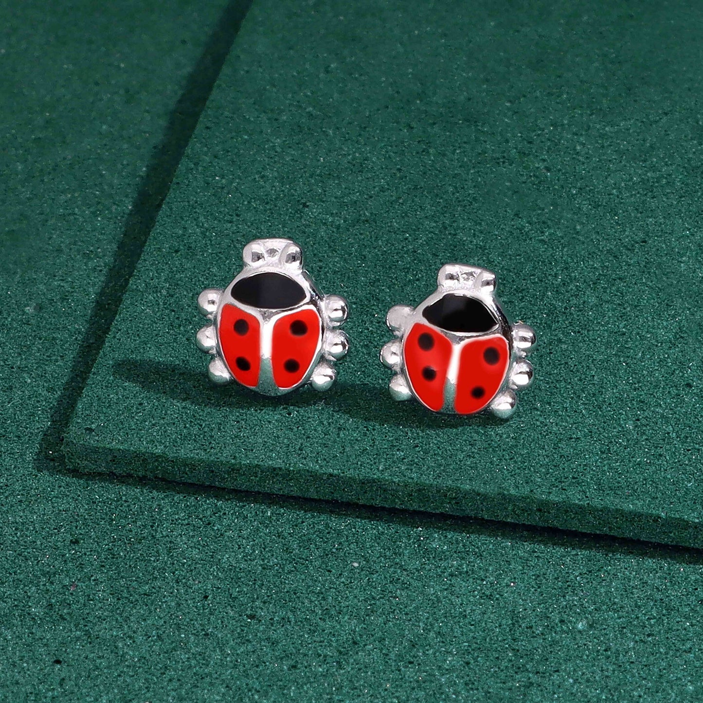 Pair of sterling silver ladybug stud earrings with red and black enamel