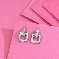 Sterling silver square earrings with cubic zirconia baguette stones