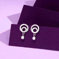Pair of silver circular drop earrings with crystal accents and dangling bead