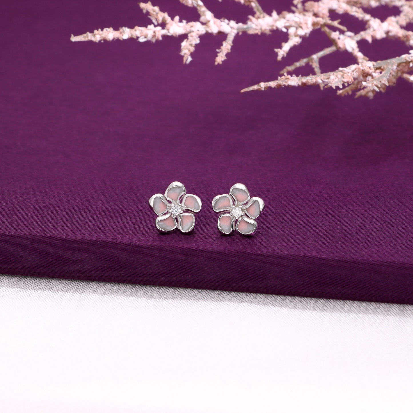 Dainty silver flower stud earrings with pink enamel petals and crystal center 