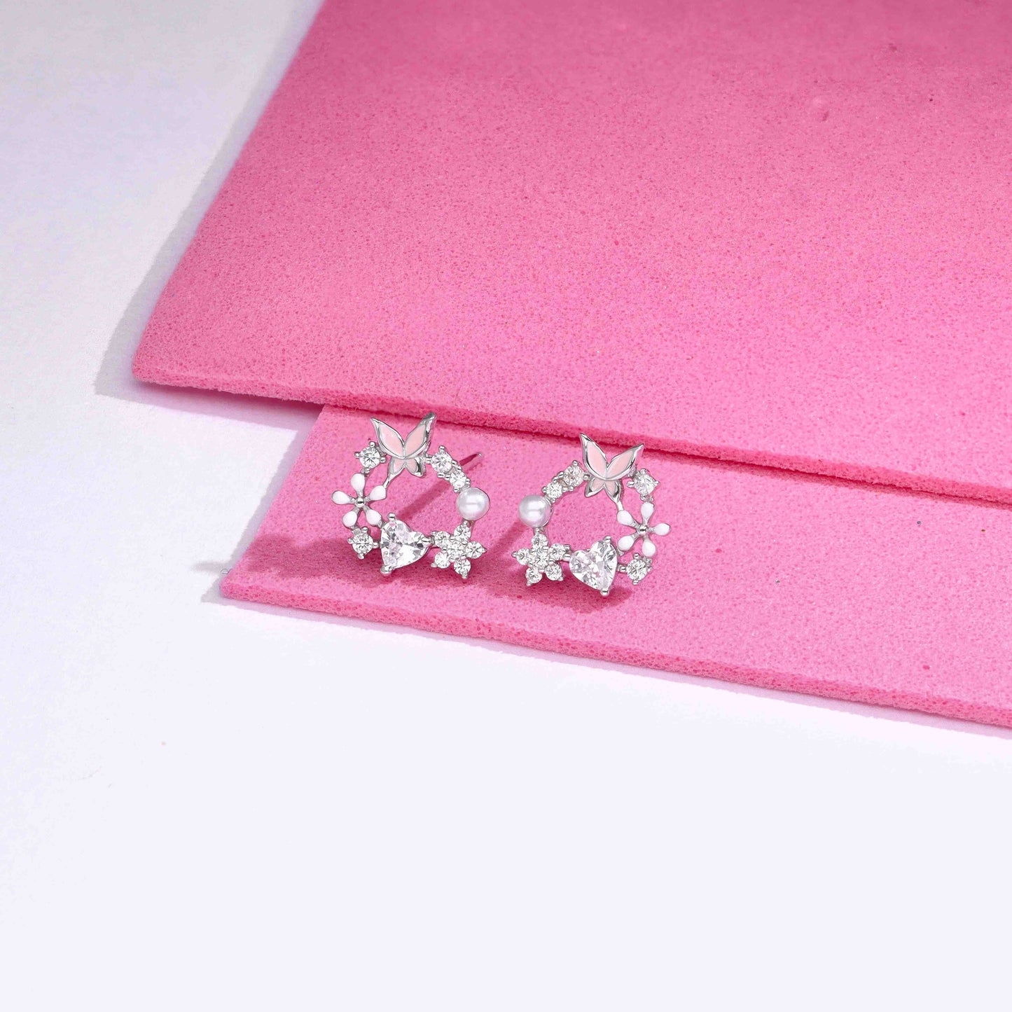 Sterling silver butterfly and floral wreath stud earrings with cubic zirconia and pearl accent