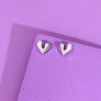 Pair of elegant silver heart shaped stud earrings