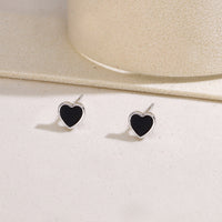 Black heart-shaped stud earrings with smooth enamel inlay set in 925 sterling