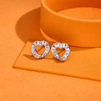 Heart-shaped 925 silver stud earrings with baguette