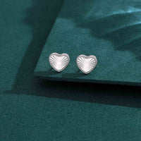 Heart-shaped sterling silver stud earrings with sunburst