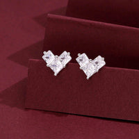 Heart-shaped stud earrings with cubic zirconia stones set in sterling silver