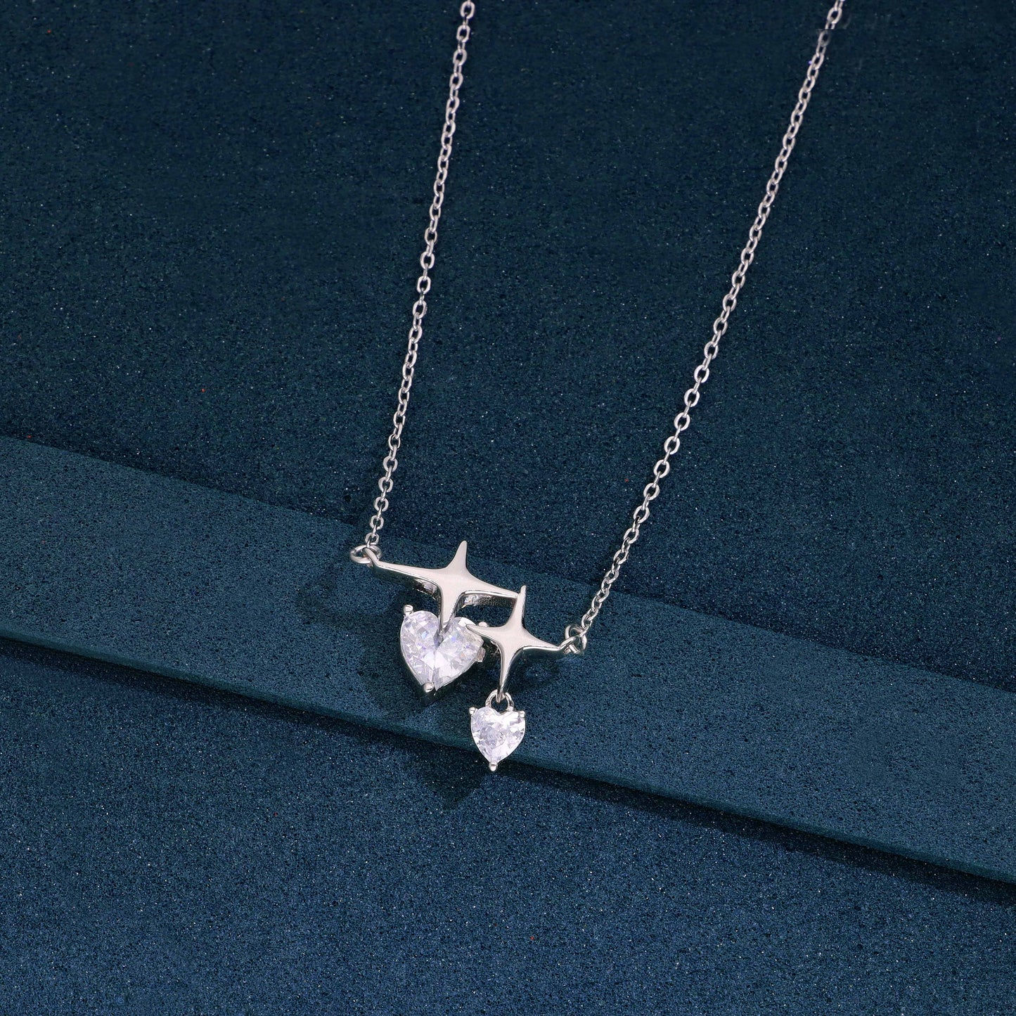 Sterling silver necklace with double heart-shaped cubic zirconia and star accent