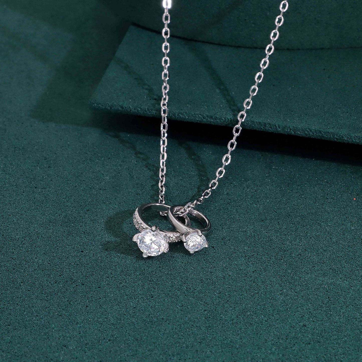 Diamond engagement and wedding rings with silver chain necklace