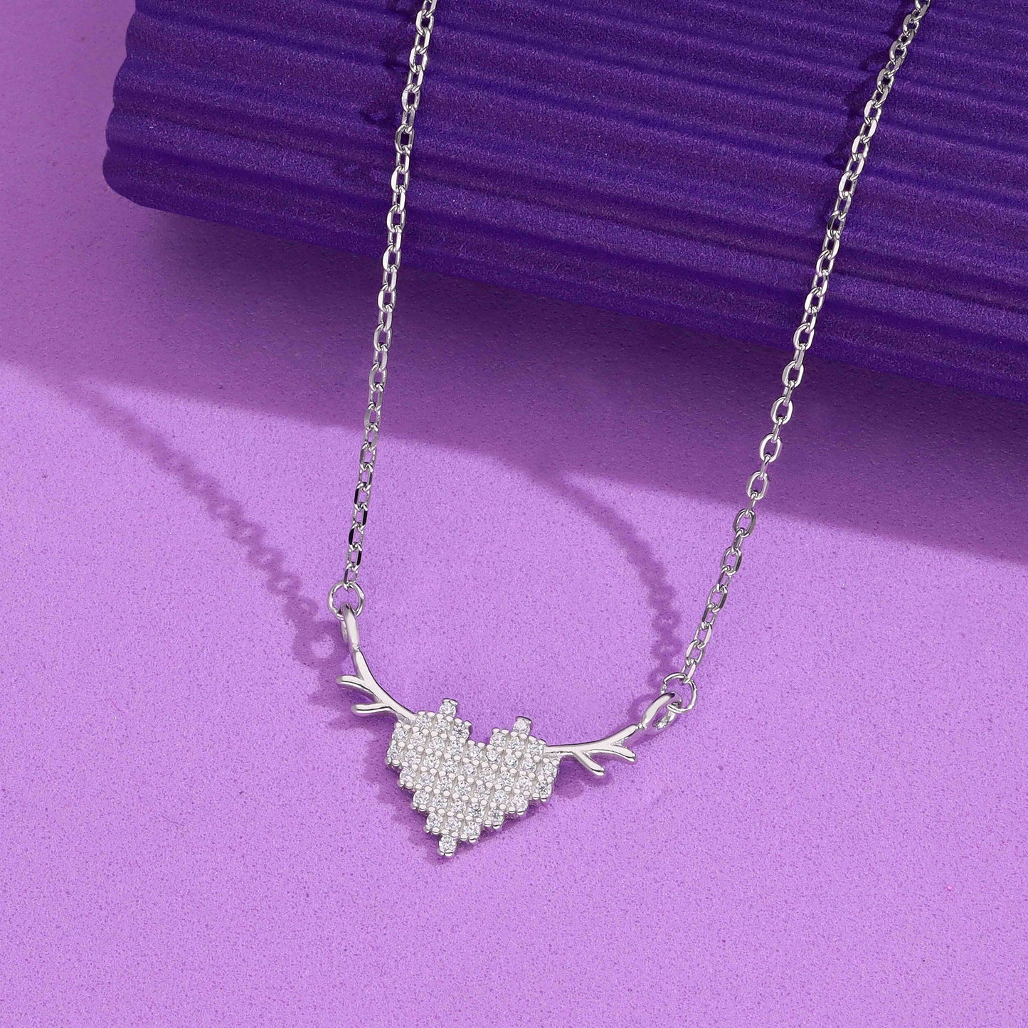 Silver heart-shaped necklace with antler design and sparkling crystals