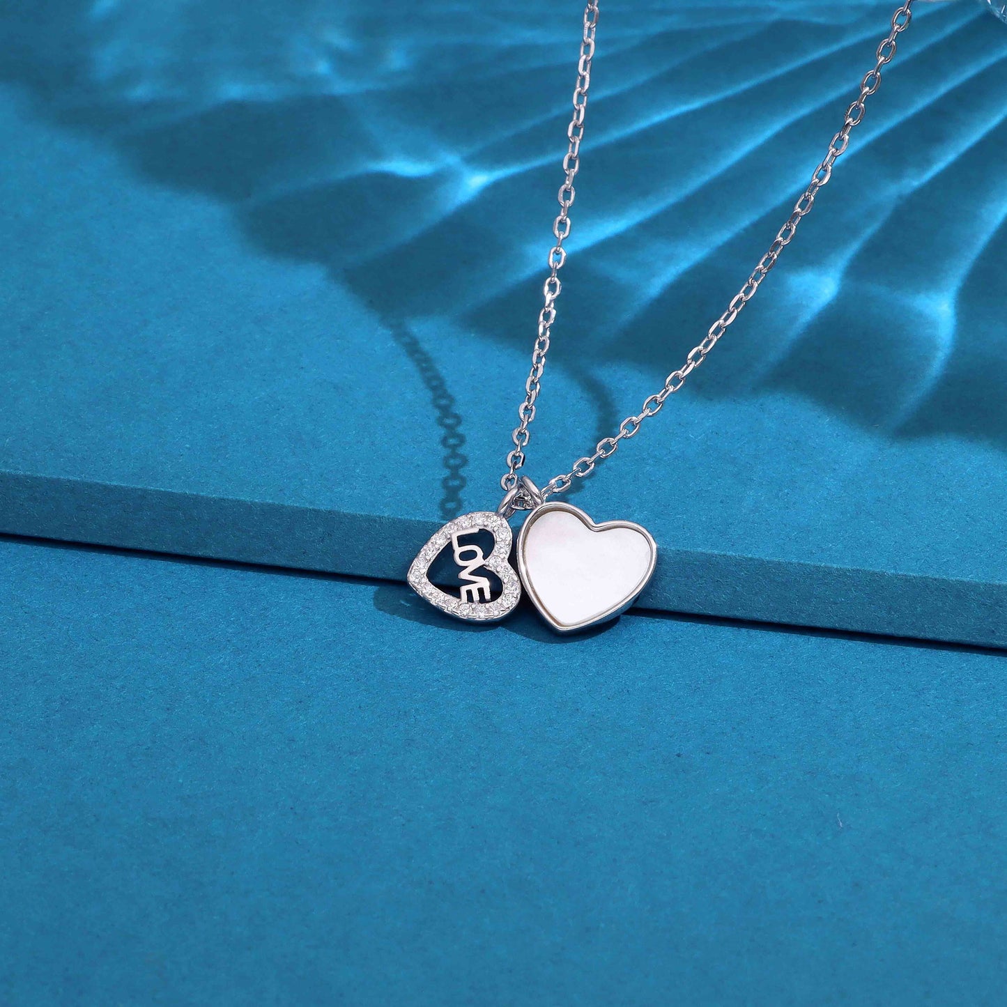 Silver-tone double heart LOVE pendant necklace with crystal-accented heart and smooth heart charm