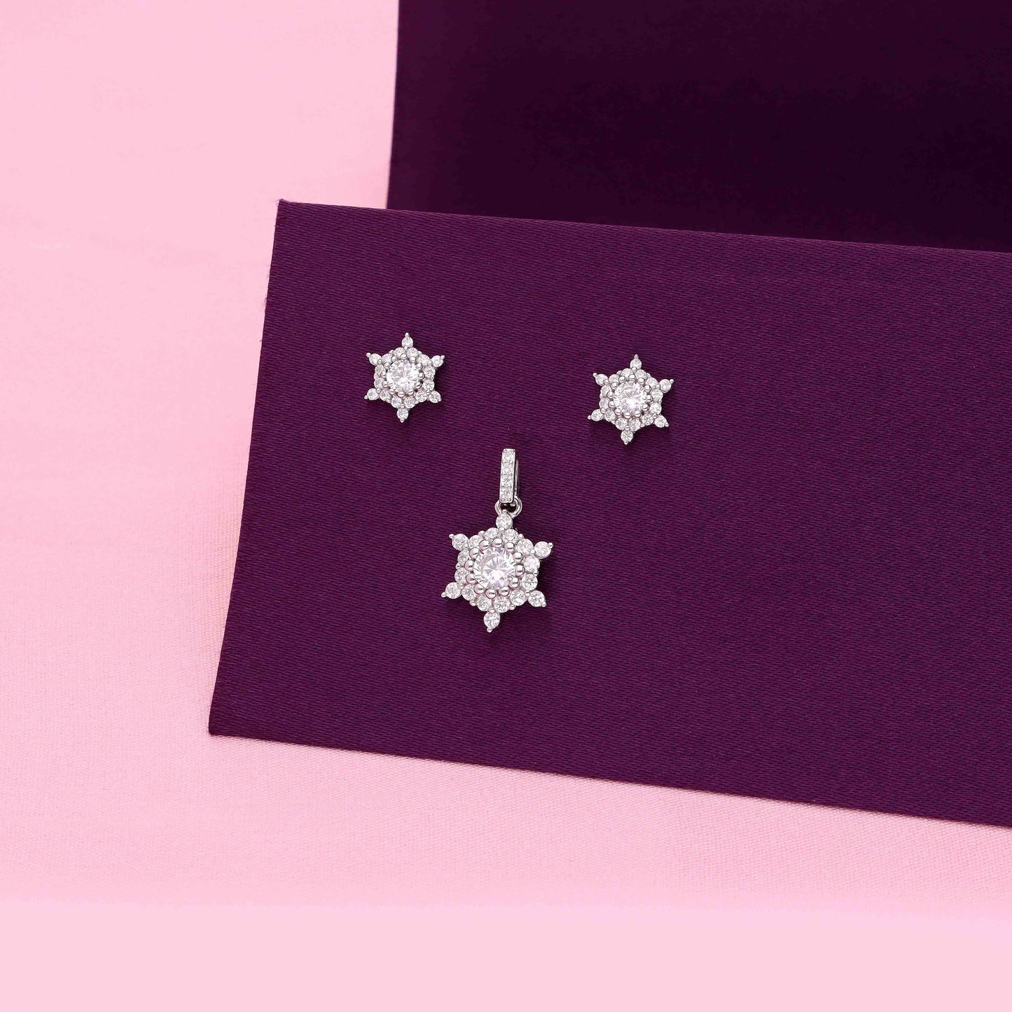 Sterling silver snowflake pendant and matching stud earrings set with cubic zirconia design