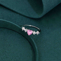 Sterling silver ring with heart-shaped pink sapphire and diamond accent