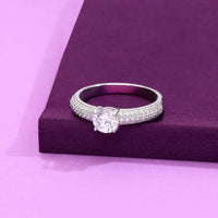 Sterling silver solitaire ring with round-cut cubic zirconia center stone and triple-row pave band